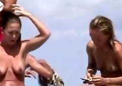 Naked sunbathing and additionally smoking chicks acquire their tits caught on spy cam