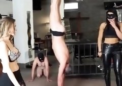 Slaves suspended upside down and spanked in BDSM session